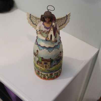 Sale Photo Thumbnail #5: Jim Shore Heartwood Creek angel figurine holding a small church, featuring a painted village scene on her skirt.