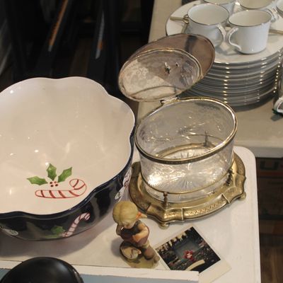 Vintage holiday serving bowl with candy cane motif, alongside a glass biscuit jar with a silver-plated lid and stand, and various white...