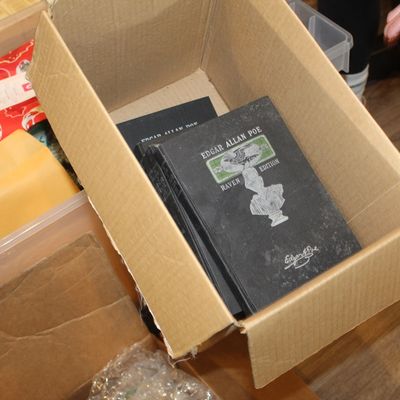 Sale Photo Thumbnail #30: Vintage Edgar Allan Poe "Raven Edition" hardcover books, featuring black covers with silver and green embossed details, stored inside a cardboard box.
