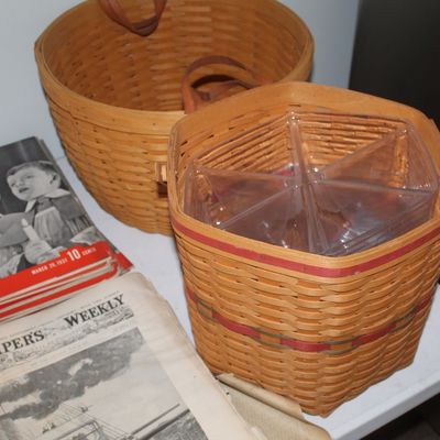 Two vintage Longaberger woven baskets, one with a clear plastic divided organizer insert, displayed next to vintage Life magazines and...