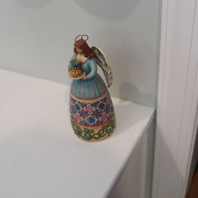 Sale Photo Thumbnail #4: Jim Shore Heartwood Creek angel figurine holding a pineapple, featuring colorful geometric patterns and a wire halo.