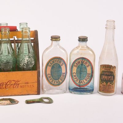Group of Coca-Cola Bottles in Branded Carrier with Other Glass Bottles and Bottle Openers.