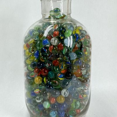 Sale Photo Thumbnail #302: COLLECTION OF GLASS MARBLES IN VINTAGE BOTTLE