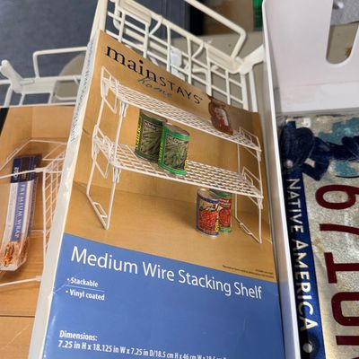 Mainstays Home vinyl-coated medium wire stacking shelf with original packaging insert, measuring 7.25 inches high by 18.125 inches wide.