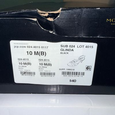 Black shoebox displaying a JCPenney product label for Glinda black strappy sandals, size 10 M(B).