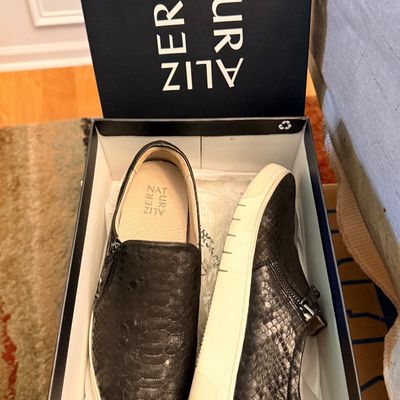 Pair of Naturalizer black snakeskin-textured slip-on sneakers with side zippers, presented in their original shoe box.