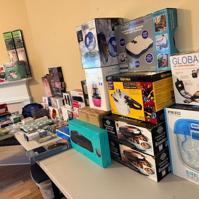 Assortment of boxed household items and electronics, including a HoMedics foot spa, Vasconia pressure cooker, and various kitchen and...