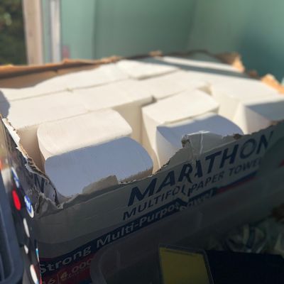Open cardboard box filled with Marathon brand multifold paper towel packs.