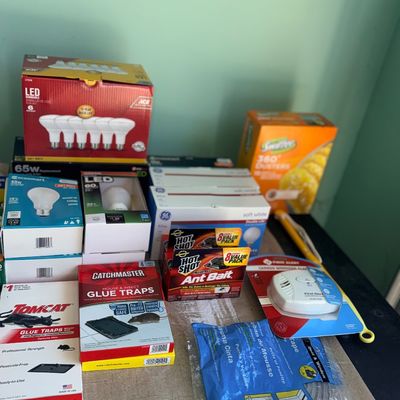 Collection of household utility supplies, including LED lightbulbs, pest control traps and bait, Swiffer dusters, weatherstripping, and a...