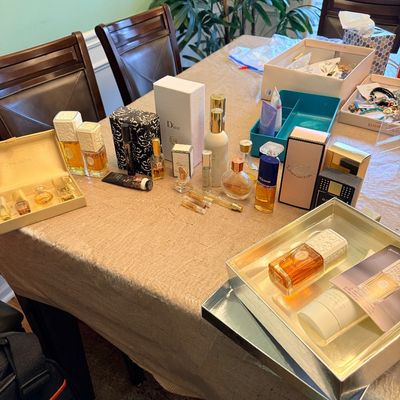 Collection of designer fragrances and cosmetics, including boxed sets and individual bottles from brands like Dior, Juicy Couture, and...