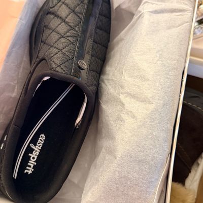 Easy Spirit black quilted slip-on shoe resting inside its original shoe box with tissue paper lining.