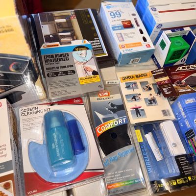 Assortment of packaged household goods, including a screen cleaning kit, weatherseal tape, insoles, and light bulbs.