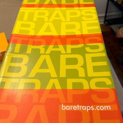 Colorful, modern Bare Traps branded shoe box featuring a repeating yellow, green, and orange typography pattern.