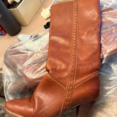Vintage cognac brown leather knee-high boot featuring woven stitch detailing along the side and a chunky stacked heel.