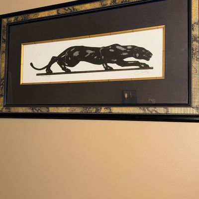 Framed black panther print titled "Black Beauty," signed by the artist and presented in a decorative black and gold metallic...