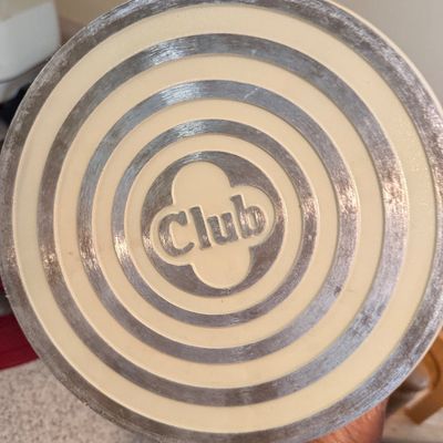 Bottom detail of a vintage Club Aluminum cookware pan featuring concentric metal rings and cream-colored enamel.