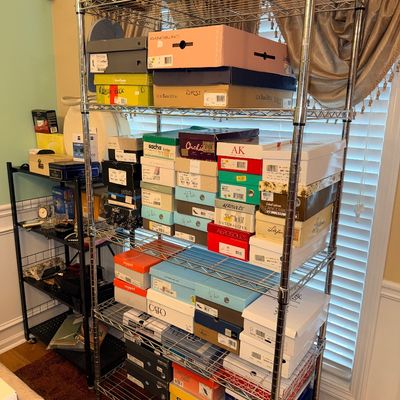Tall chrome wire shelving unit stacked with various shoe boxes from brands including G.H. Bass, Aerosoles, and Bandolino.
