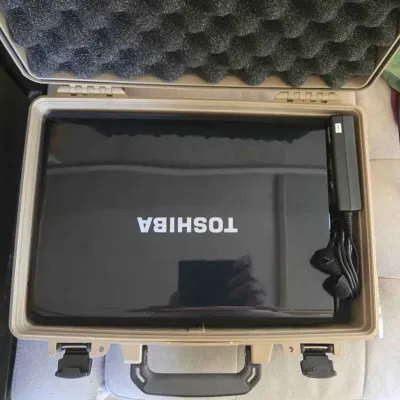 Sale Photo Thumbnail #59: Toshiba laptop with power adapter, stored inside a rugged, foam-lined tan protective carrying case.