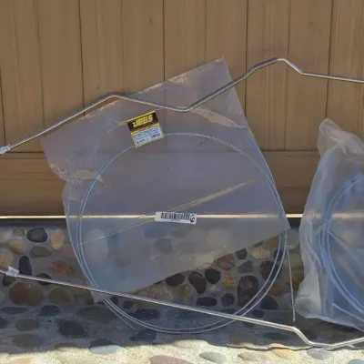 Sale Photo Thumbnail #76: JEGS automotive tubing coils in original plastic packaging, shown alongside pre-bent metal lines.