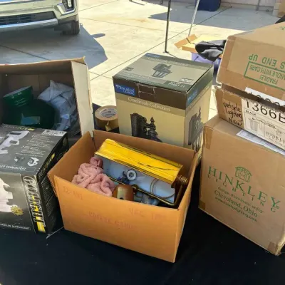 Sale Photo Thumbnail #81: Assorted outdoor and indoor lighting fixtures, including a Golight remote-controlled searchlight, a Progress Lighting Cranbrook collection fixture, and a Hinkley outdoor light, some in original packaging.