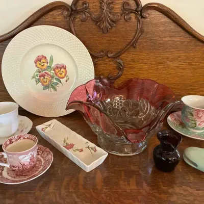 Sale Photo Thumbnail #170: Assorted vintage tableware including a Johnson Brothers "Friendly Village" teacup and saucer, a floral pansy plate, a ruffled cranberry glass bowl, and other decorative porcelain pieces.