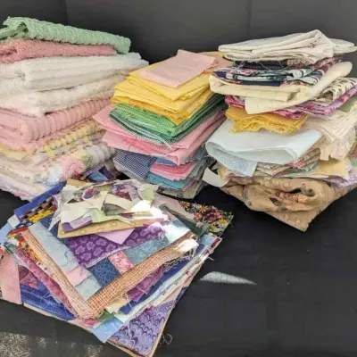 Sale Photo Thumbnail #58: Large assortment of vintage fabric scraps, quilt squares, and textiles in various colors and patterns.