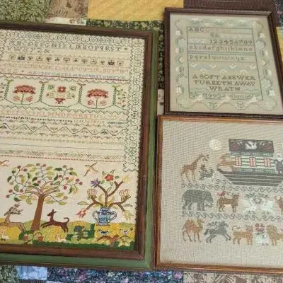 Sale Photo Thumbnail #79: Three framed needlepoint samplers, including a large traditional alphabet and pictorial sampler, a smaller alphabet sampler dated 1993, and a Noah's Ark themed piece.
