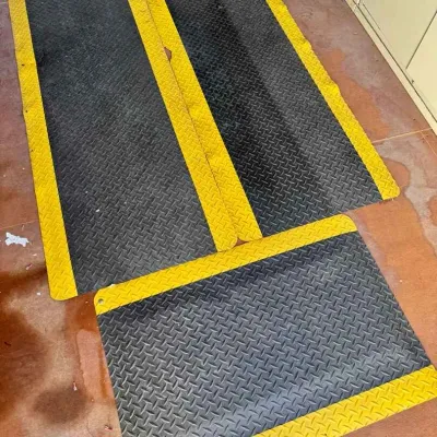 Sale Photo Thumbnail #38: Three heavy-duty industrial anti-fatigue floor mats featuring a black diamond-plate texture and high-visibility yellow safety borders.