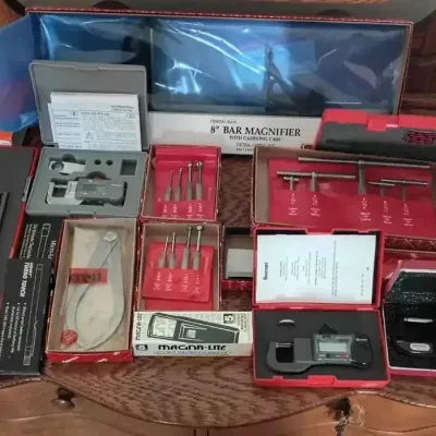 Sale Photo Thumbnail #149: DSC04354.JPG: Collection of precision measuring tools, including Starrett micrometers, calipers, a combination square set, and a bar magnifier, mostly in their original cases.