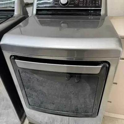 Sale Photo Thumbnail #25: Modern LG front-load dryer in a metallic graphite finish, featuring a digital control panel and glass door.