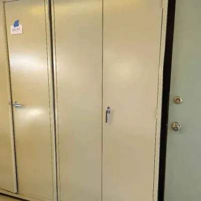 Sale Photo Thumbnail #121: Tennsco beige metal double-door storage cabinet on casters, showing some light wear from garage use.