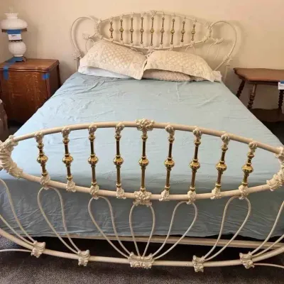 Sale Photo Thumbnail #165: Vintage white and brass metal bed frame featuring ornate scrollwork and spindle details on the headboard and footboard.