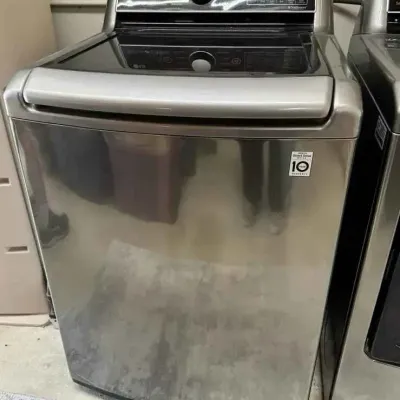 Sale Photo Thumbnail #24: LG top-load washing machine with a stainless steel finish and digital control panel.