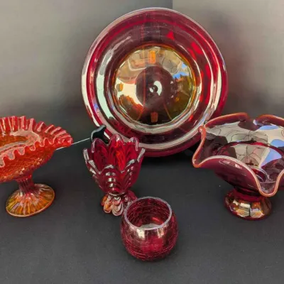 Sale Photo Thumbnail #21: Collection of vintage red and amberina glass tableware, including ruffled compotes, a small vase, a crackle glass cup, and a large round platter.