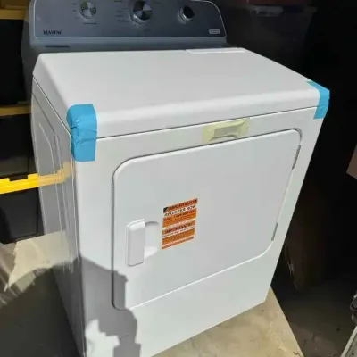 Sale Photo Thumbnail #26: Modern Maytag white front-load clothes dryer, appearing in like-new condition with original manufacturer stickers and protective blue tape still attached.