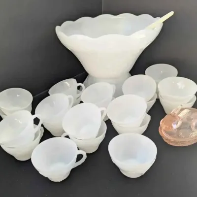 Sale Photo Thumbnail #73: Vintage white milk glass punch bowl set with matching cups and a plastic ladle, accompanied by a small pink glass bunny dish.