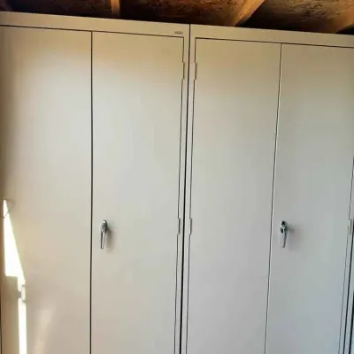 Sale Photo Thumbnail #39: Pair of tall, beige metal storage cabinets with double doors and locking handles, suitable for garage or workshop organization.