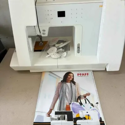 Sale Photo Thumbnail #15: Pfaff Passport line sewing machine, shown with original styrofoam packaging, accessories in a plastic bag, and the owner's manual.