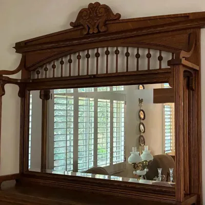 Sale Photo Thumbnail #142: Antique oak sideboard mirror featuring a carved crest, spindle gallery, and fluted side columns.
