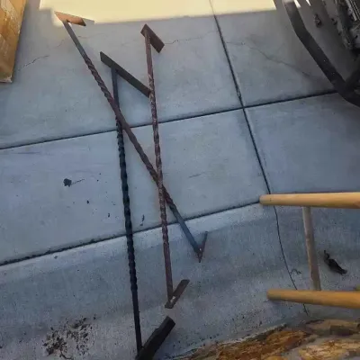 Sale Photo Thumbnail #61: Three vintage wrought iron fireplace pokers with twisted shafts and angled heads, showing some surface rust.