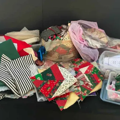 Sale Photo Thumbnail #68: Large assortment of quilting and sewing supplies, including fabric scraps, pre-cut quilt squares, and notions stored in plastic bins.