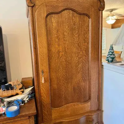 Sale Photo Thumbnail #171: Antique French oak armoire featuring a single door with a key, a bottom drawer, and a curved bonnet top.