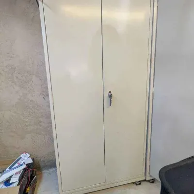 Sale Photo Thumbnail #10: Industrial beige metal storage cabinet with double doors, a locking handle, and caster wheels for mobility.