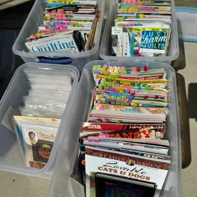 Sale Photo Thumbnail #82: Four clear plastic storage bins filled with quilting magazines, patterns, and coloring books, many organized with colorful sticky tabs.