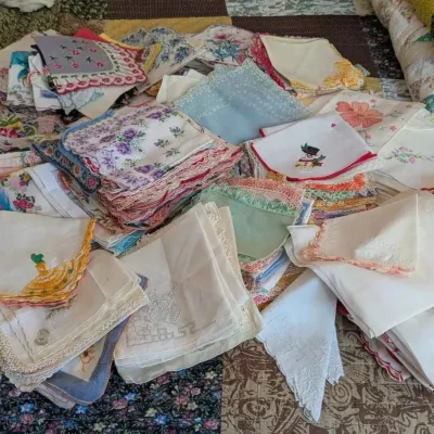 Sale Photo Thumbnail #92: Large collection of vintage ladies' handkerchiefs featuring various embroidered floral patterns, lace trims, and colorful designs.
