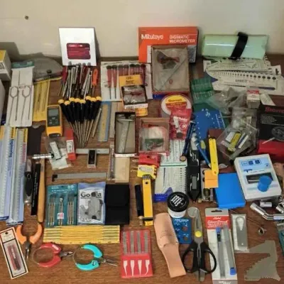 Sale Photo Thumbnail #87: Assortment of precision measuring tools and hand tools, including a Mitutoyo digimatic micrometer, Starrett dial indicator, rulers, calipers, and screwdrivers.
