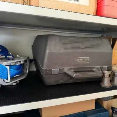 Sale Photo Thumbnail #125: Vintage Craftsman Permanex tool case sitting on a shelf alongside a blue strap winch and other hardware.