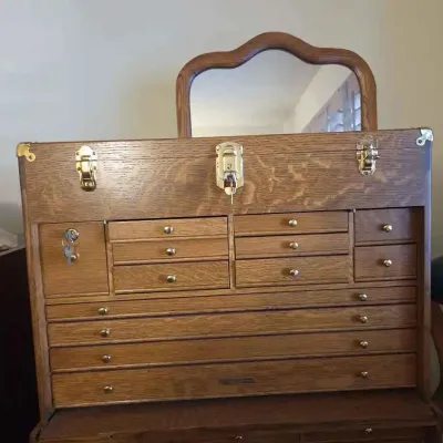 Sale Photo Thumbnail #4: Gerstner-style oak machinist tool chest featuring a top storage compartment with an inset mirror, multiple small drawers, and brass hardware with keys.