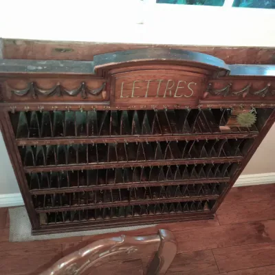 Sale Photo Thumbnail #5: Antique French wooden mail sorter cabinet featuring carved details, numbered slots, and "LETTRES" inscribed on the arched top pediment.
