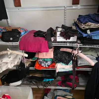 Sale Photo Thumbnail #116: Assorted women's clothing, accessories, and shoes organized on wire closet shelving.